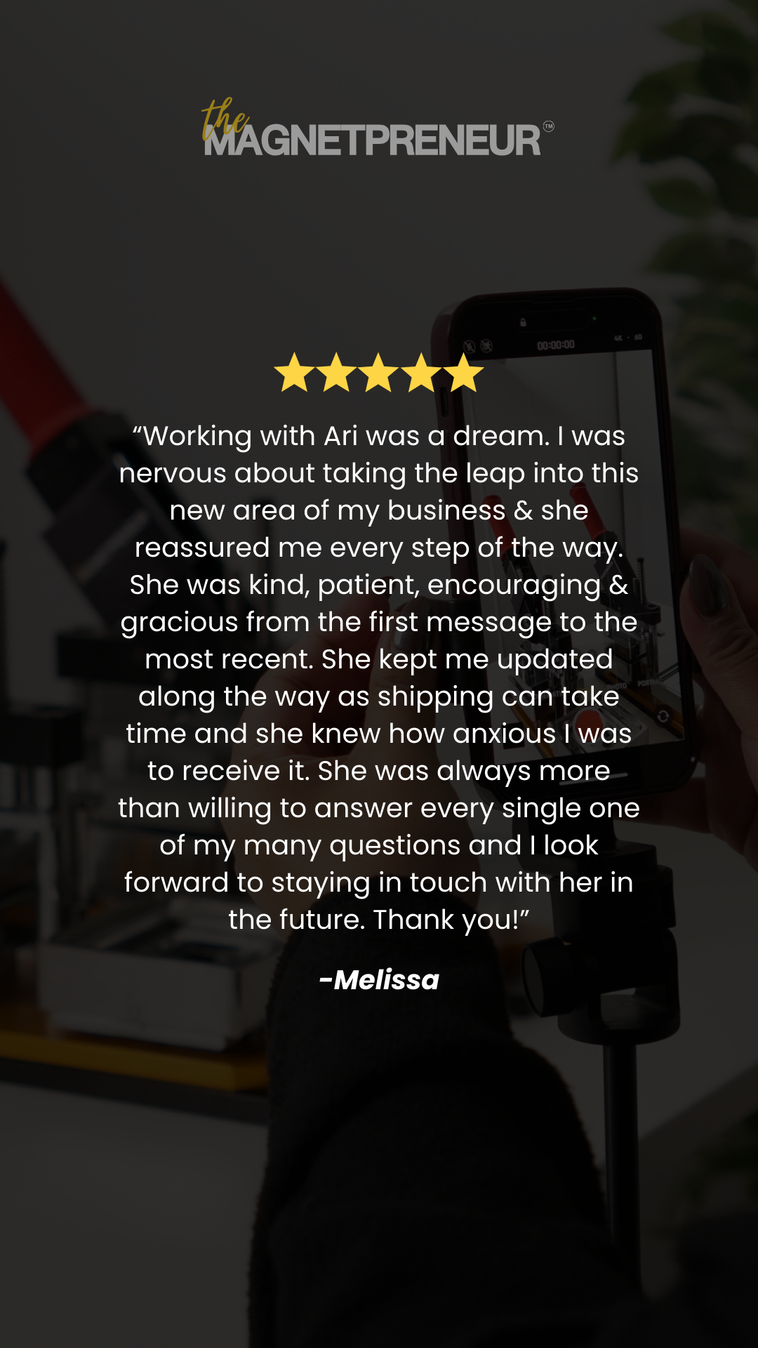 Phone screen displaying a five-star review for 'The Magnetpreneur' with a blurred background